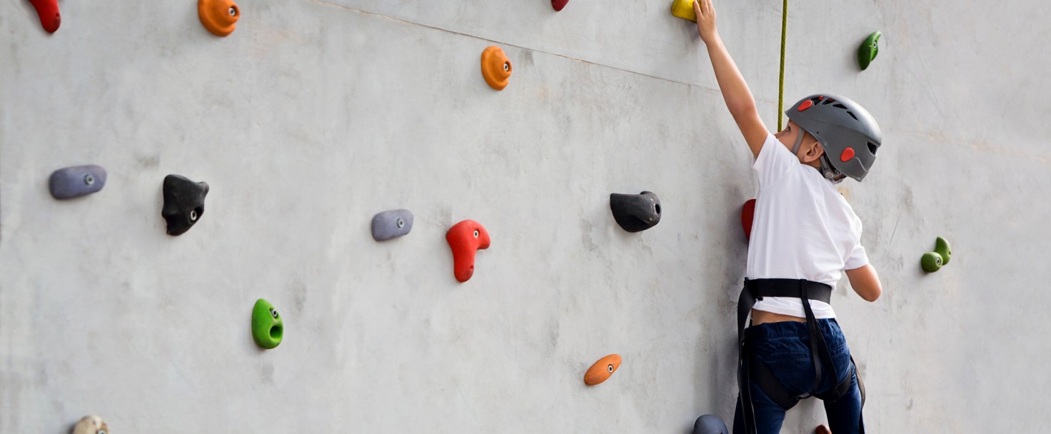 Boy climbing up wall