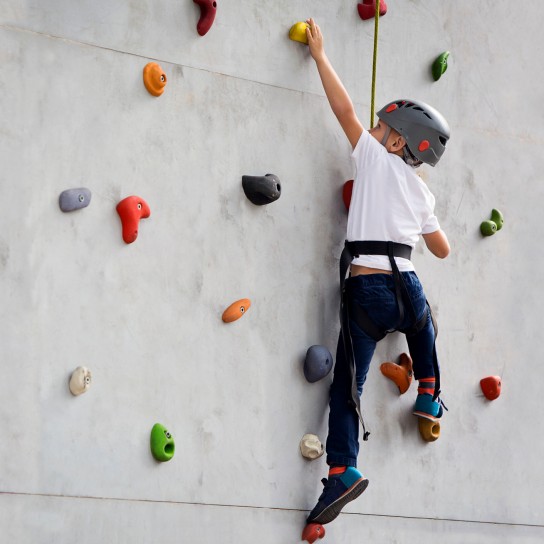 Boy climbing up wall