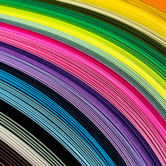 Layers of various colored papers in stack close-up view