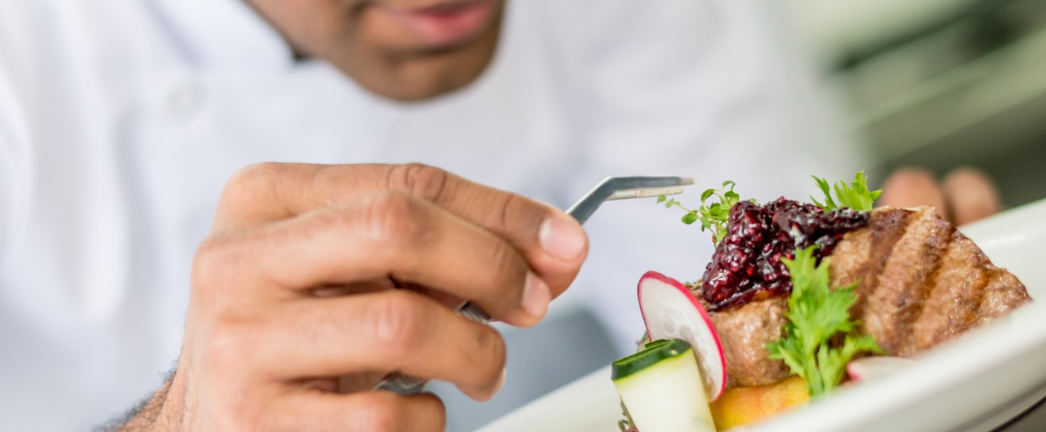 Chef decorating a plate and working at a restaurant â?? food concepts