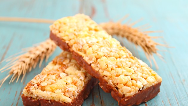 healthy snack, muesli bars with raisins and nuts on a blue background