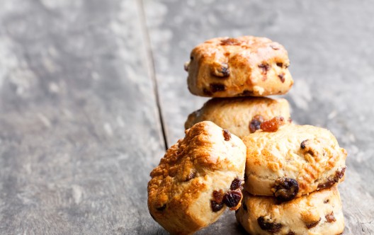 Homemade sultana scones on wooden table