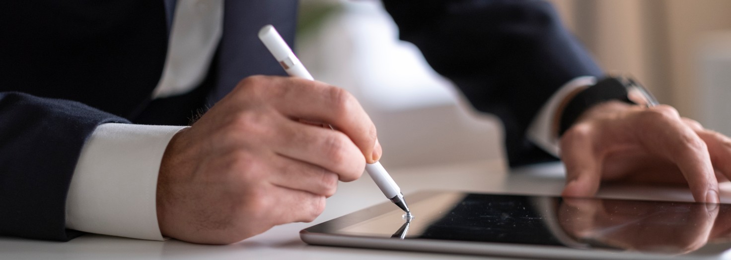 Businessman Signing Digital Contract On Tablet Using Stylus Pen
