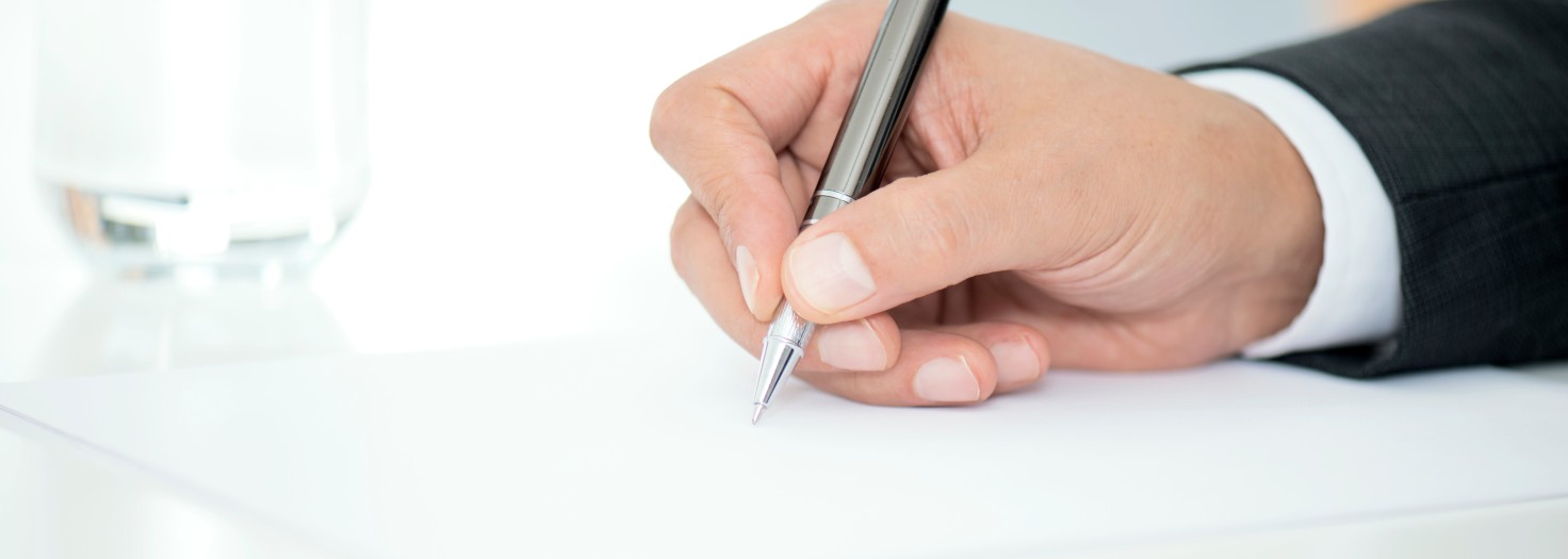   Man Signing Contract Paper