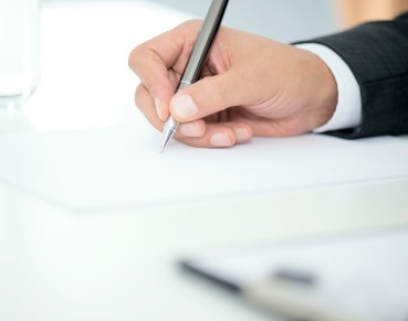 Man Signing Contract Paper