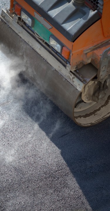 Heavy vibration roller compactor at asphalt pavement works for road repairing