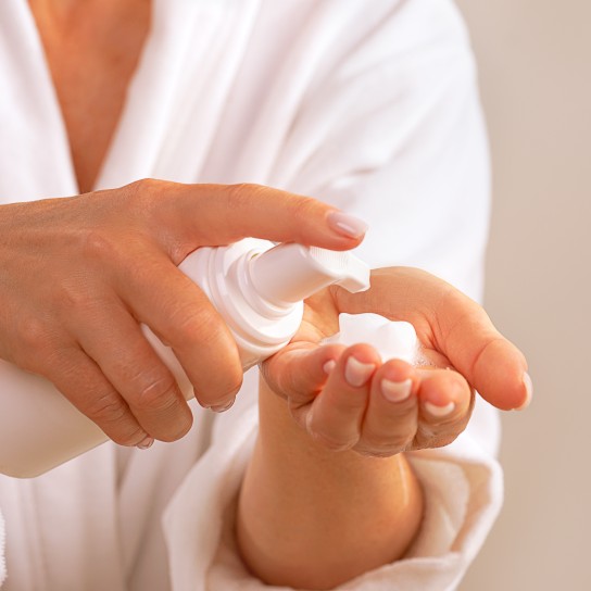 Beautiful Woman in white bathrobe holds Beauty Product Soap or Cosmetic Milk or washing Foam, Moisturizing Facial Cream. Concept of home face and body self care and healthy lifestyle. Trendy pink nude manicure. Close-up. Copy space.
GettyImages-1360030563.jpg