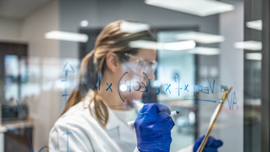 Formulation writen on glass wall by woman