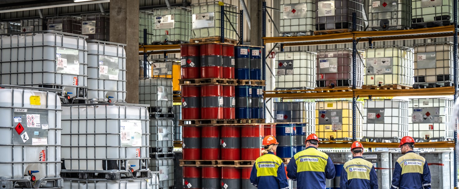 Four Brenntag employees walking in the warehouse, Duisburg, Germany