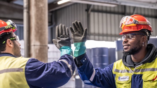 Employees high-fiving during work, Duisburg, Germany