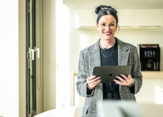 Confident business woman looking in the camera and holding a tablet, Essen, Germany