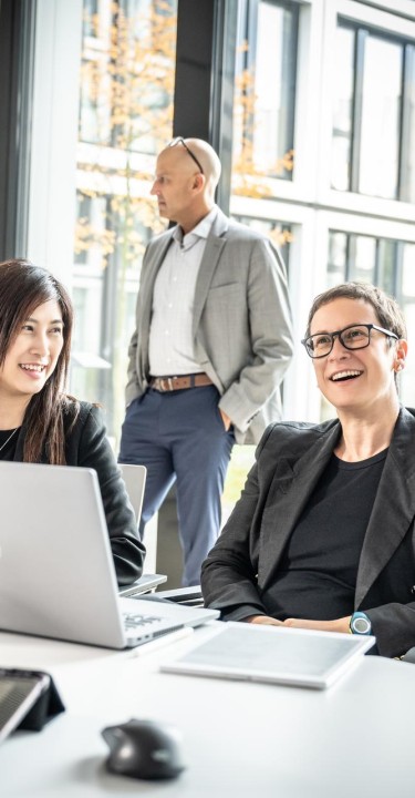Business women discussing topic with their laptop open, Essen, Germany