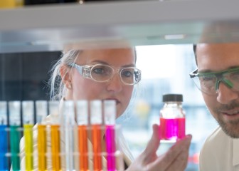 Colleagues in the application kitchen checking the color of the liquid, Essen, Germany