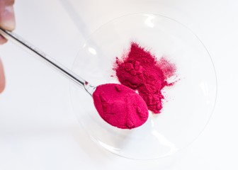 Checking the texture of the powder in the application center, Essen, Germany