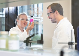 Colleagues in the application kitchen checking the color of the liquid, Essen, Germany