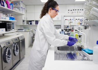 Woman washing a glass in an application center
