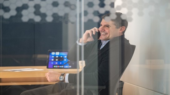 Business man talking on his mobile device and smiling, Houston, USA