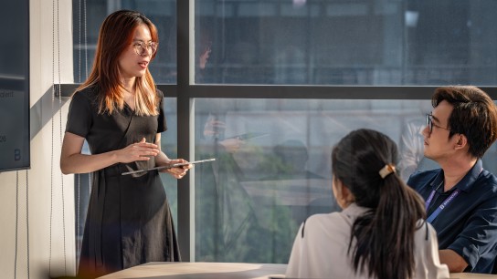 Three persons having a meeting