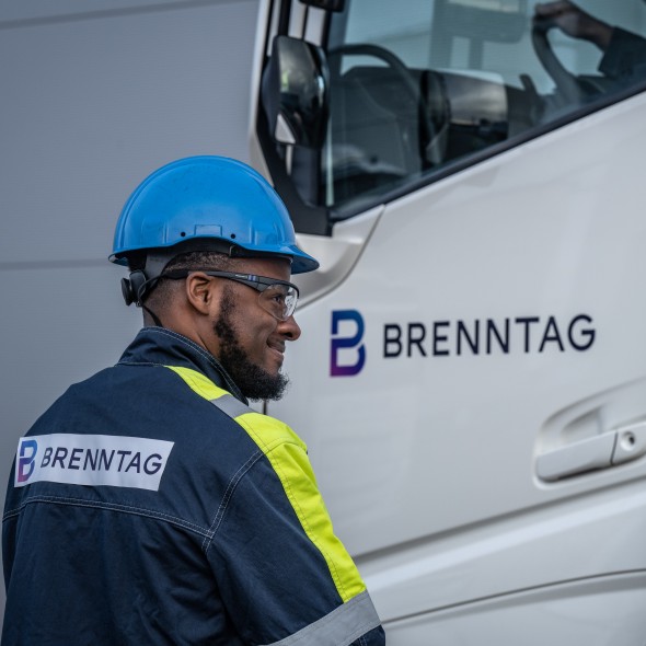 Smiling Brenntag employee in front of a truck, Rotterdam, The Netherlands