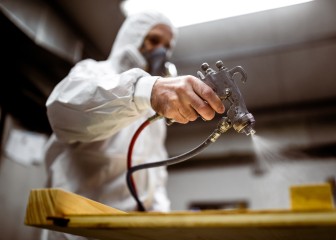 Carpenter painting wood with spray gun
GettyImages-1300268889.jpg