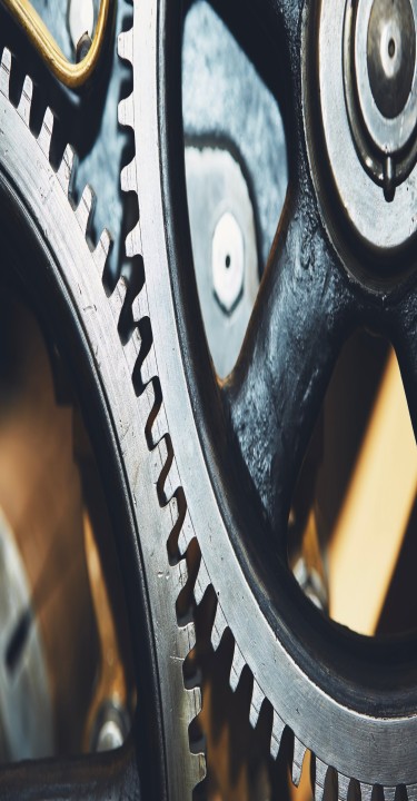 Close up of metal cog wheel in engine of machine