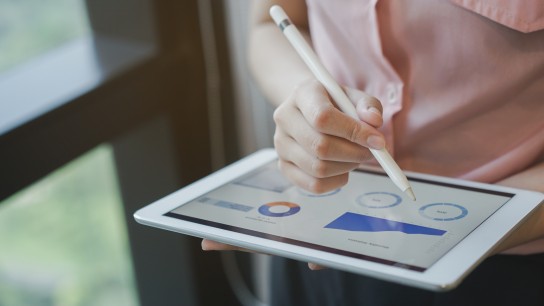 close up on businesswoman manager hand using stylus pen for writing or comment on screen dashboard tablet in meeting situation about company's performance , technology and business strategy concept