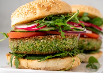 Closeup of vegetarian plant based burgers with aragula and broccoli patty, sliced radish, tomato and cucumber. Fresh vegan meal for veggie restaurant menu. Sesame bun on top of meatless snack
GettyImages-1365808785.jpg