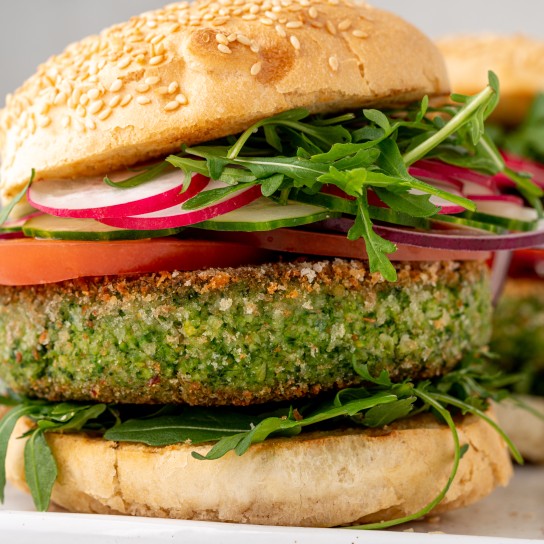 Closeup of vegetarian plant based burgers with aragula and broccoli patty, sliced radish, tomato and cucumber. Fresh vegan meal for veggie restaurant menu. Sesame bun on top of meatless snack
GettyImages-1365808785.jpg
