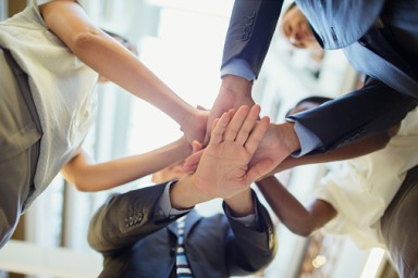 Business people putting hands together