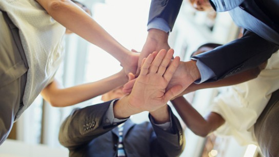 Business people putting hands together