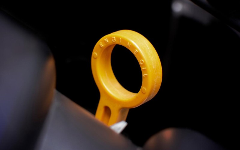 Dipstick oil level gauge with Yellow color for Checking engine oil level of engine system, automotive part concept.