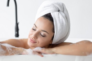 Woman relaxing in bathtub