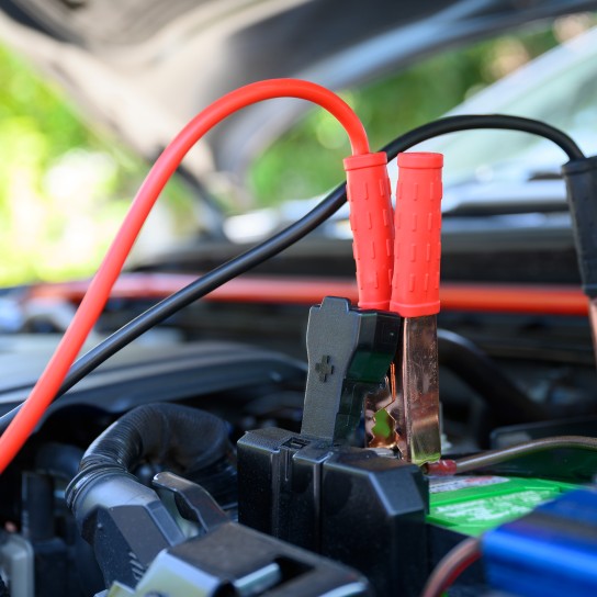 Close up battery jumper cables connect to car battery for charging dead battery