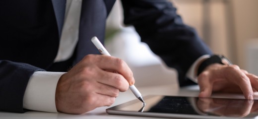 Businessman Signing Digital Contract On Tablet Using Stylus Pen