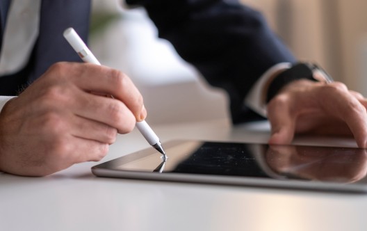 Businessman Signing Digital Contract On Tablet Using Stylus Pen