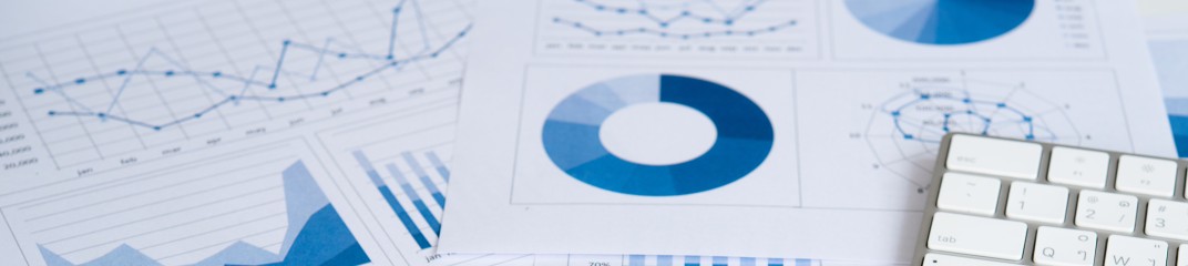 Business graphs and charts report with keyboard computer on desk of financial advisor. Financial abstract concepts.