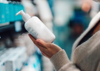 Young woman doing grocery shopping in supermarket. Plastic bottle mockup for packaging design.