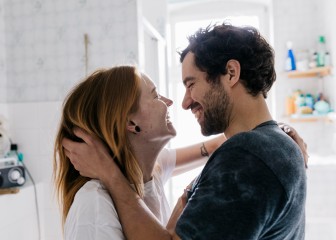 A couple  affectionately embracing each other and smiling after meeting on an online dating app.
