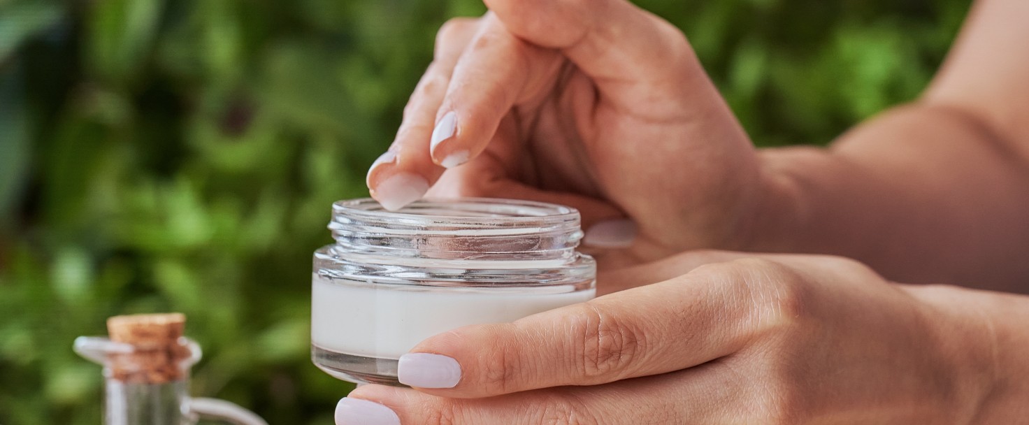 Close up of woman hands holding jar of moisturizing cream. Beauty treatment concepts