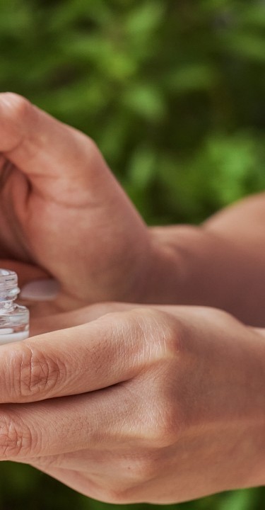 Fingers of a woman with balsem.