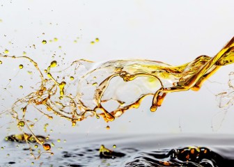 Golden oil drops, splashing water