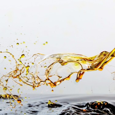 Golden oil drops, splashing water