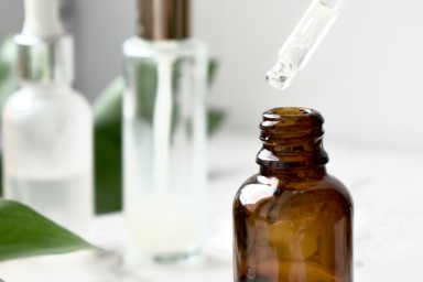 Facial serum, care cosmetics, facial and body treatments, anti-aging lotion, glass jar with pipette