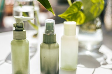 Line up of green  lotions and potions in various shapes-casting shadows.conceptual.green ecology