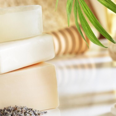 All natural soaps stacked up in a spa type atmosphere.