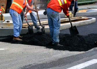 Workers preparing asphalt parking lot