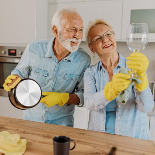Senior couple washing dishes
