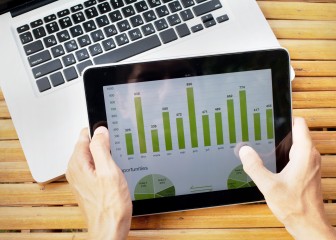 hands of farmer with tablet with infographics on the screen