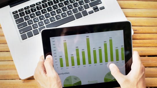 hands of farmer with tablet with infographics on the screen