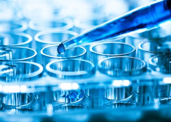 Pipette and drop of liquid with microtubes.